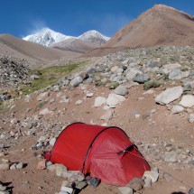 The base camp Guanaquitos on a sunny morning, but storm on the peaks due to the snow cloud